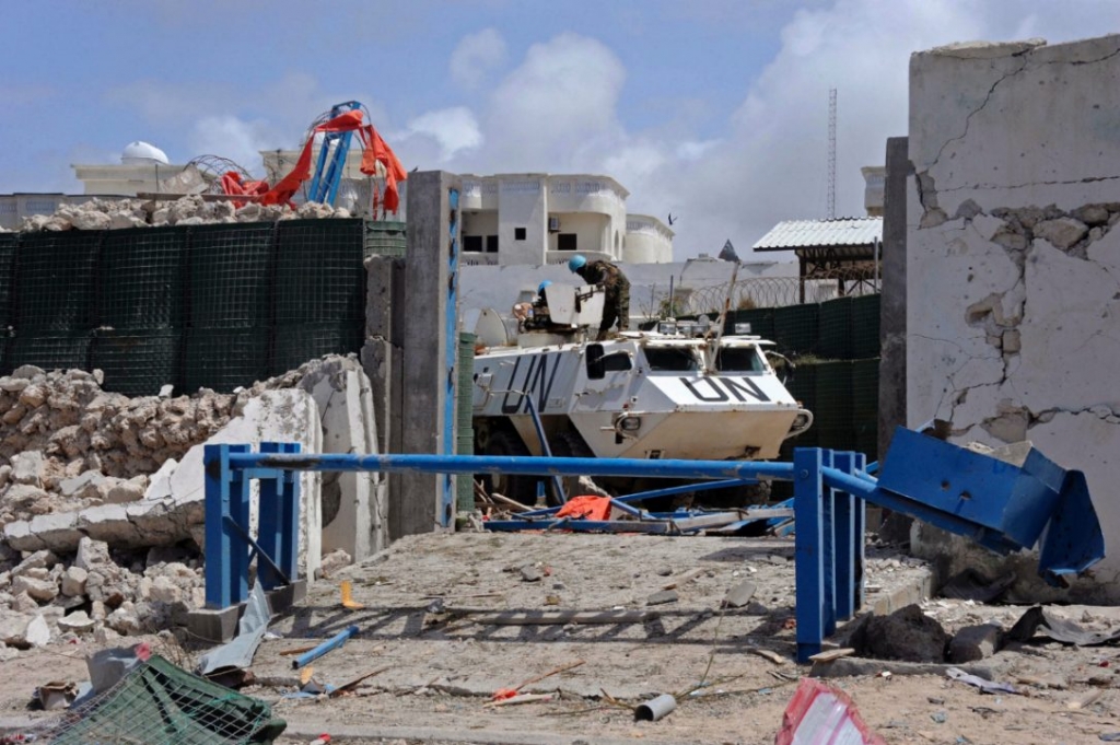 United Nations soldiers secure a partially-crumbled perimeter wall following twin car bombings outside the UN's office in Mogadishu on Thursday