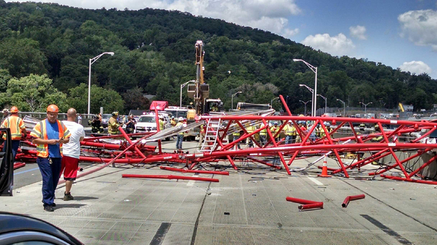 A giant crane sits road bed of the Tappan Zee Bridge north of New York City after toppling around noon on Tuesday