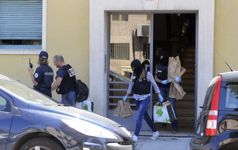 French investigating police carry evidence bags after they conducted a search at the apartment and a truck the day after a heavy a truck ran into a crowd at high speed killing scores and injuring more who were celebrating the Bastille Day national holida