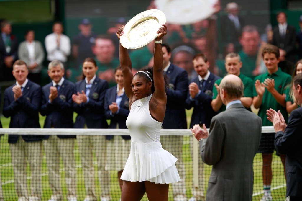 Serena Williams of The United States lifts the trophy following victory in The Ladies Singles Final