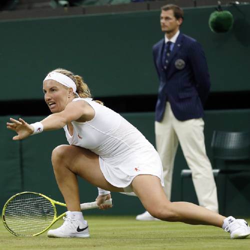 Russia slips during her women's singles match against Caroline Wozniacki of Denmark on day two of the Wimbledon Tennis Championships in London Tuesday