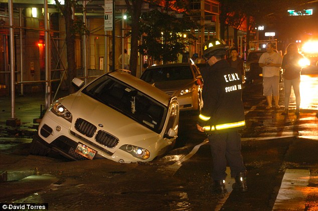 A BMV SUV has been swallowed up by a sinkhole in New York City's Upper West Side