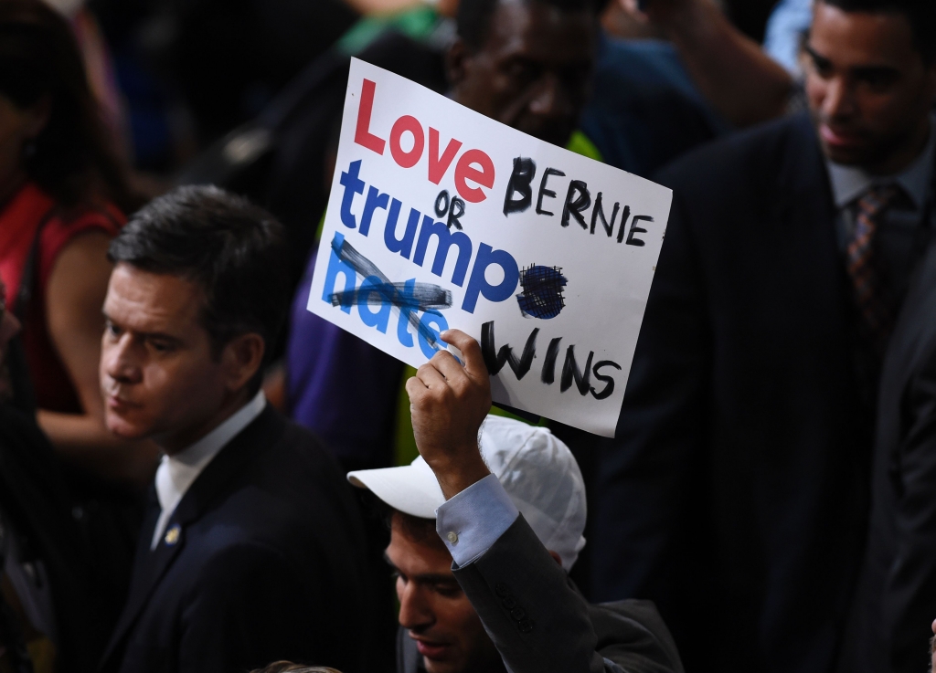 A Bernie Sanders supporter holds up a sign on the first day of the Democratic National Convention in Philadelphia.  AFP