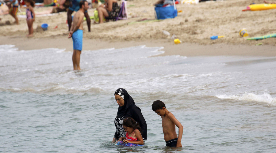 A Muslim woman wears a burkini on a beach in Marseille France