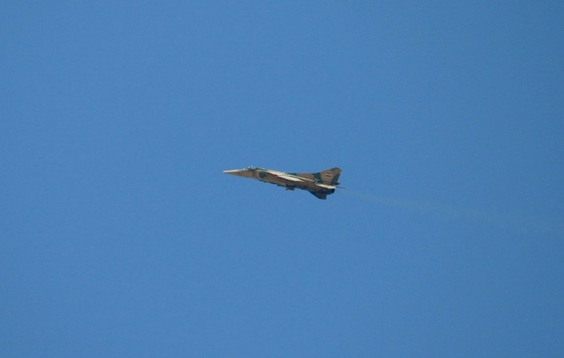 A Syrian army jet flies over a rebel-held area of Daraa in southern Syria