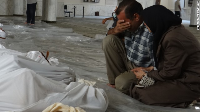 A Syrian man mourns over the bodies of those killed in an alleged chemical weapons attack in Damascus Syria in 2013