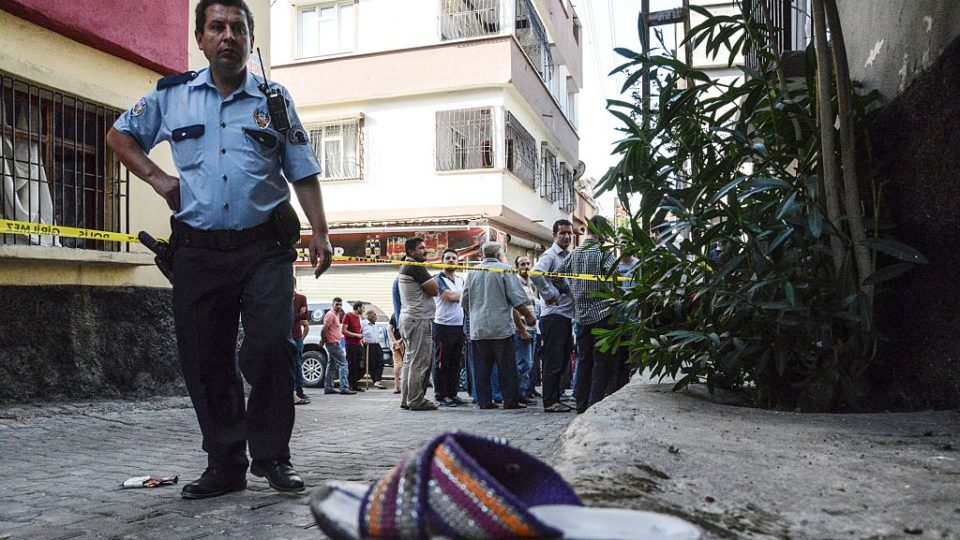 A Turkish policeman stands next to a shoe near the explosion scene