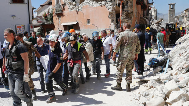 A body is carried away by rescuers following an earthquake in Amatrice central Italy on Wednesday. REUTERS  Ciro De Luca