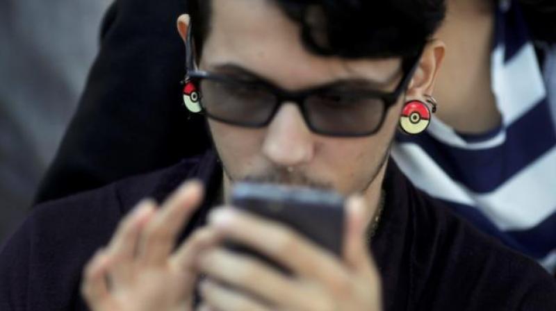 20A boy plays Pokemon Go in an urban park in Rio de Janeiro