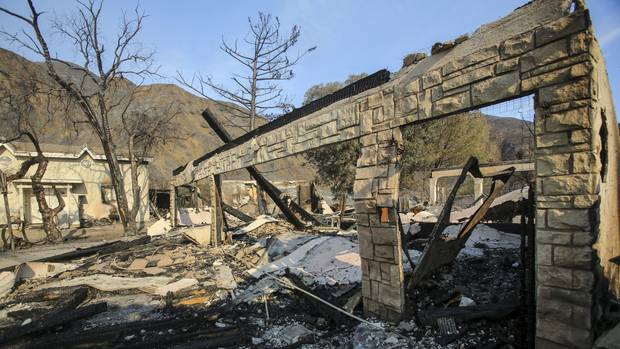 A burned home near Iron Canyon Road in Santa Clarita California after a wildfire forced thousands from their homes