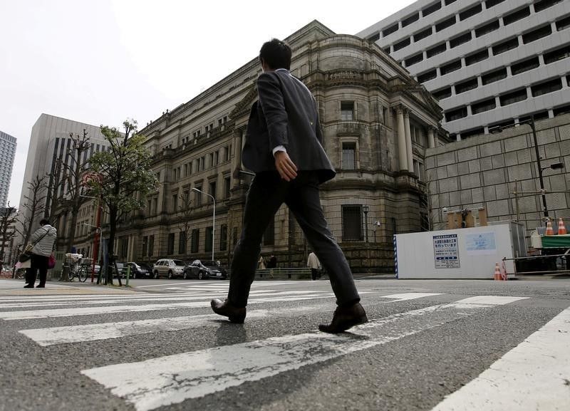 Businessman walks past the Bank of Japan building in Tokyo