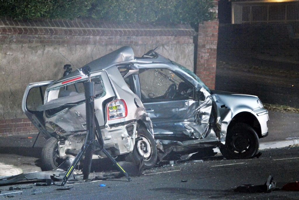 Two people killed after car smashes into parked vehicles