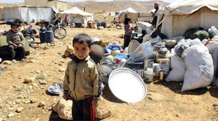 A child waiting in a refugee camp for his father to come back