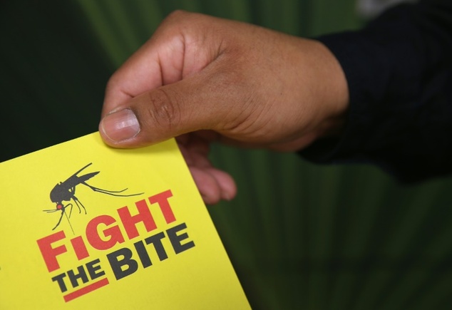 A city environmental health worker displays literature to be distrubuted to the public