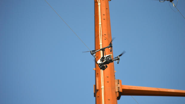 A drone piloted by Sky Skopes staff flies near a utility pole Aug. 29 south of Emerado N.D