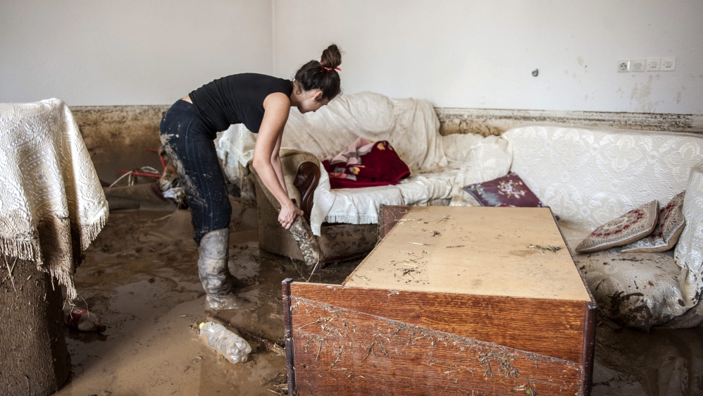 A girl begins to clean up her flood hit home in the village of Stajkovci Skopje