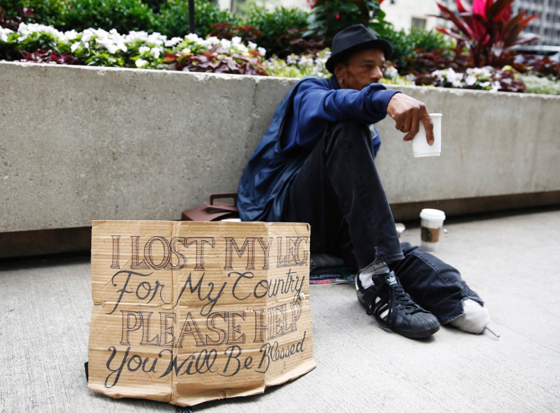 A homeless veteran displays a redesigned cardboard sign in downtown Chicago