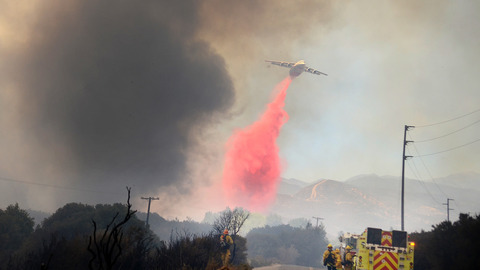 A jet tanker drops retardant on a fire along Highway 173 in Hesperia California