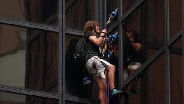 A man climbs the outside of Trump Tower in New York