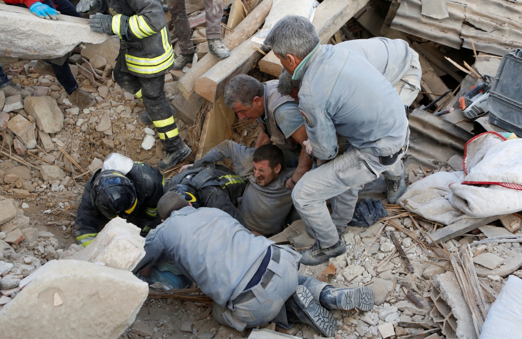 A man is rescued from the rubble caused by a 6.2-magnitude earthquake in central Italy on Wednesday