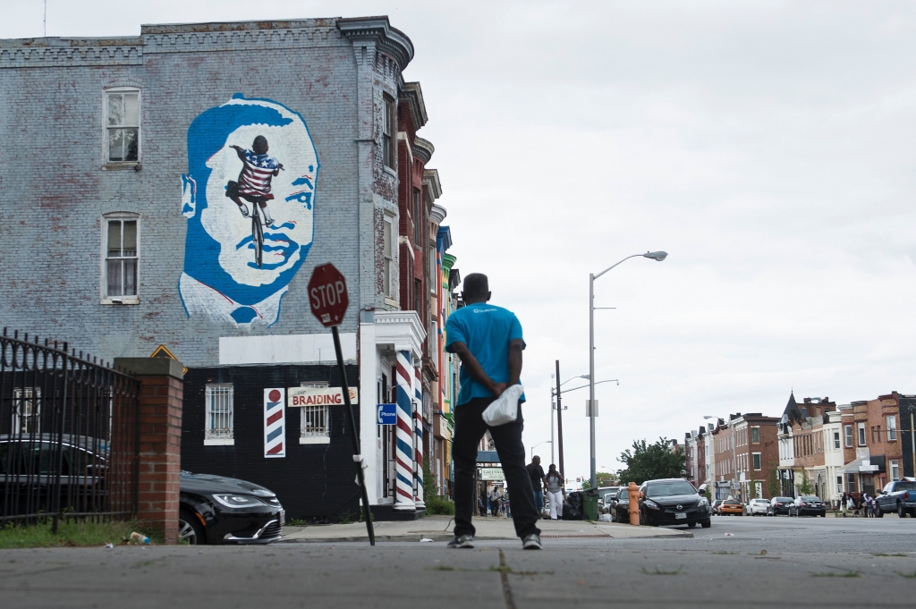 A man looks to a mural on June 23 in the area where riots broke out after the funeral for Freddie Gray last year in Baltimore