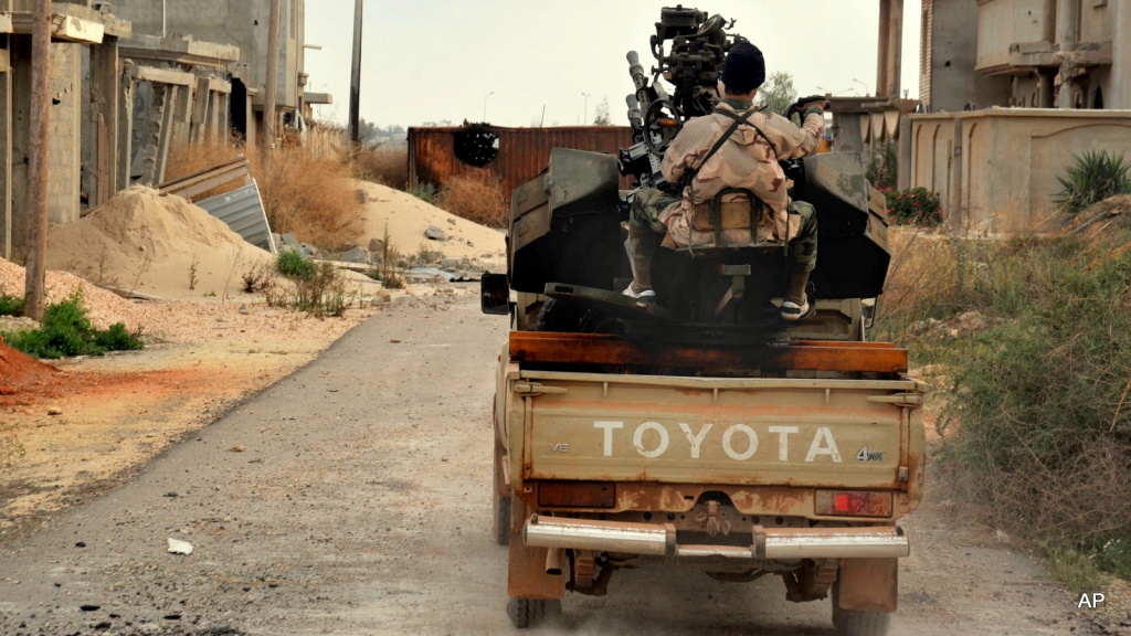 A man loyal to the Libyan armed forces prepares himself for clashes with Islamic State group militants west of Benghazi Libya