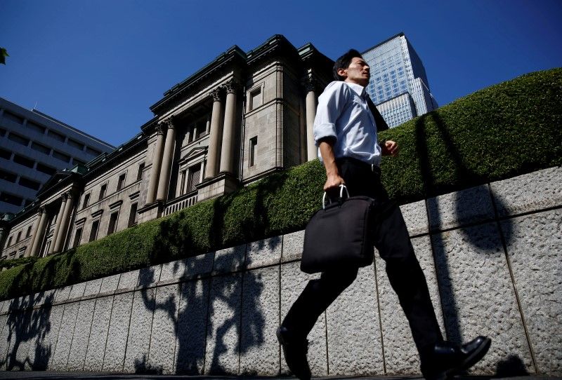 A man runs past the Bank of Japan building in Tokyo