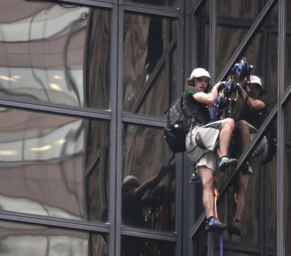 A man scales Trump Tower on Wednesday using suction cups. New York police officers dragged him through a window to safety