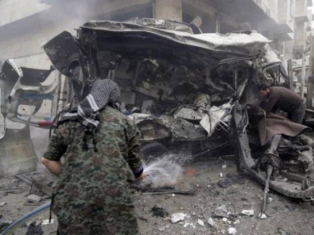 A man sprays water on an ambulance at a site hit by what activists said were three consecutive air strikes