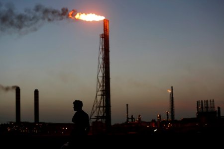 A man stands close to the Cardon refinery which belongs to the Venezuelan state oil company PDVSAn in Punto Fijo Venezuela