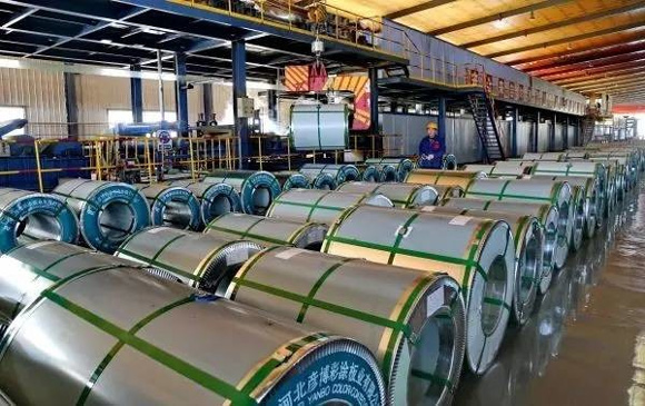 A man works on a steel plate production line in Qian'an City Hebei Province