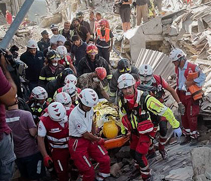 A survivor is pulled out of the rubble in Amatrice central Italy where a 6.1 earthquake struck just after 3:30 a.m. Wednesday Aug. 24 2016