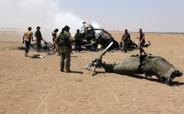 August 2016 reportedly shows Syrian rebels gathered round the wreckage of a downed Russian military helicopter