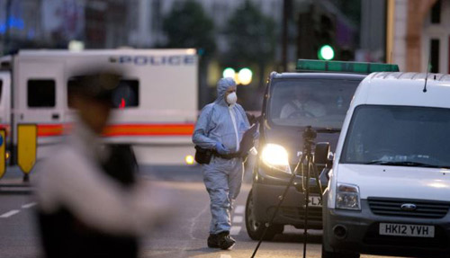 A police forensic officer works in Russell Square in London early on Aug. 4 2016 after a knife attack in which a woman in her 60s was killed. /AFP