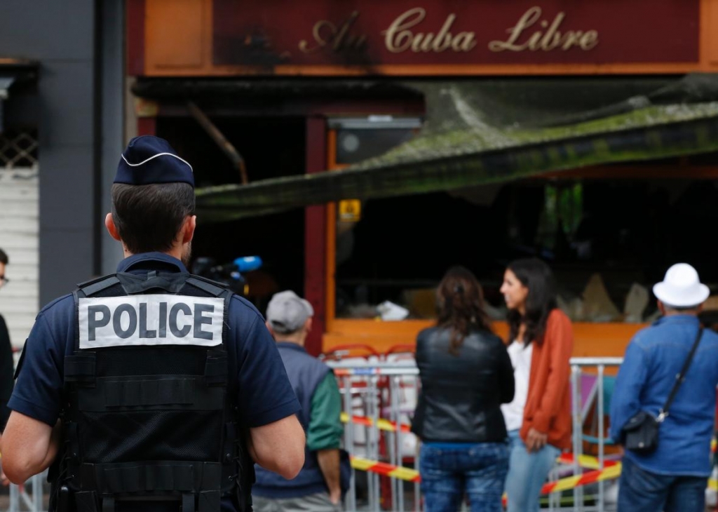 586335738-police-officer-stands-outside-the-damaged-au-cuba-libre