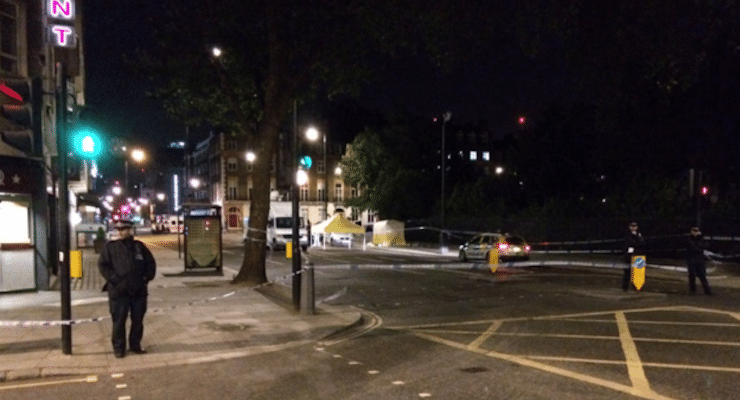 A police officers stands watch by the forensics tent set up next to the park in Russell Square in central London near the British Museum