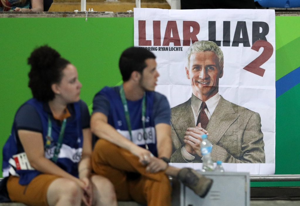 A poster showing a likeness of American swimmer Ryan Lochte at a stadium in Rio