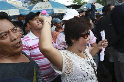 A protester center throws a water bottle at Thai soldiers during an anti-coup demonstration at the Victory Monument in Bangkok Thailand. File