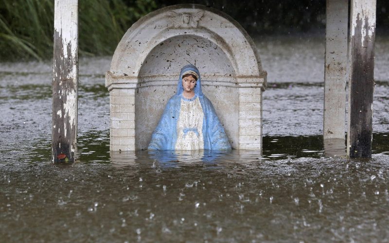 A statue of Mary is seen partially submerged in flood water in Sorrento Louisiana August 20