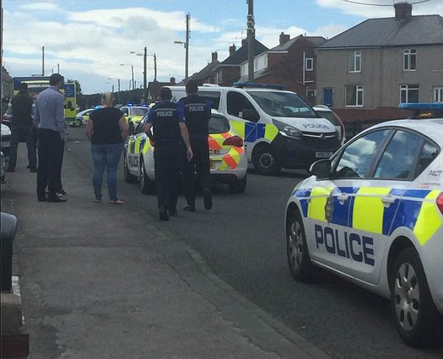 A village is on lockdown as armed police hunt down a knifeman stabbed a man to death