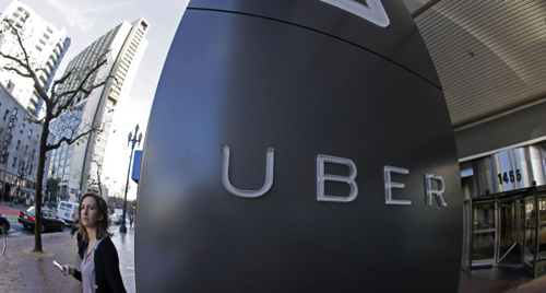 A woman leaves Uber headquarters of Uber in San Francisco California. /AP