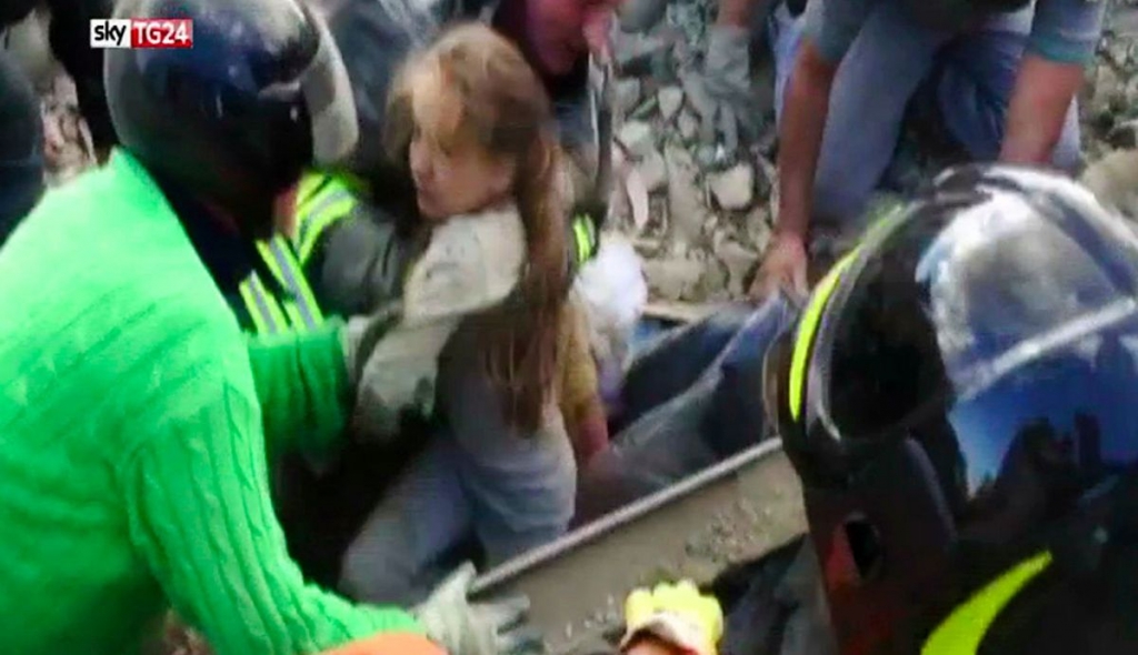 A 10-year-old girl is pulled alive from the rubble following an earthquake in Pescara Del Tronto