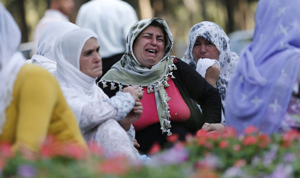 AFPFamily members of the victims mourn in the streets close to wear the attack happened