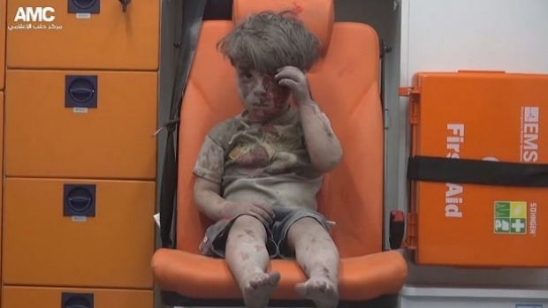 A still from footage from the pro-rebel Aleppo Media Centre shows a child rescued from rubble after an air strike in Aleppo