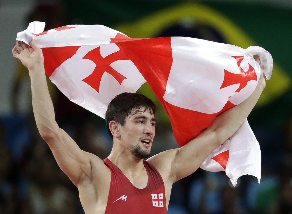 Georgia's Vladimer Khinchegashvili celebrates after defeating Japan's Rei Higuchi to win the gold in the men's wrestling freestyle 57-kg competition at the 2016 Summer Olympics in Rio de Janeiro Brazil Friday Aug. 19 2016. (AP