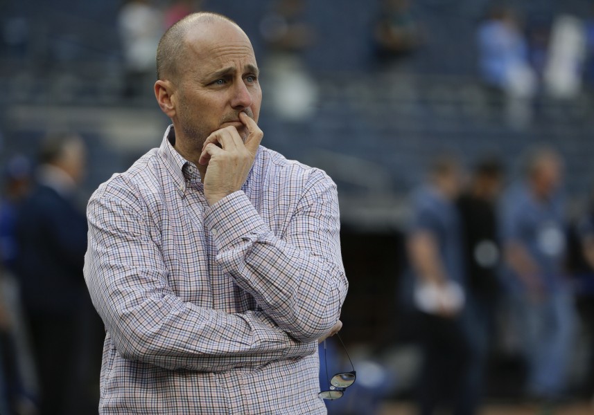 New York Yankees general manager Brian Cashman watches batting practice before a baseball game against the Kansas City Royals Thursday