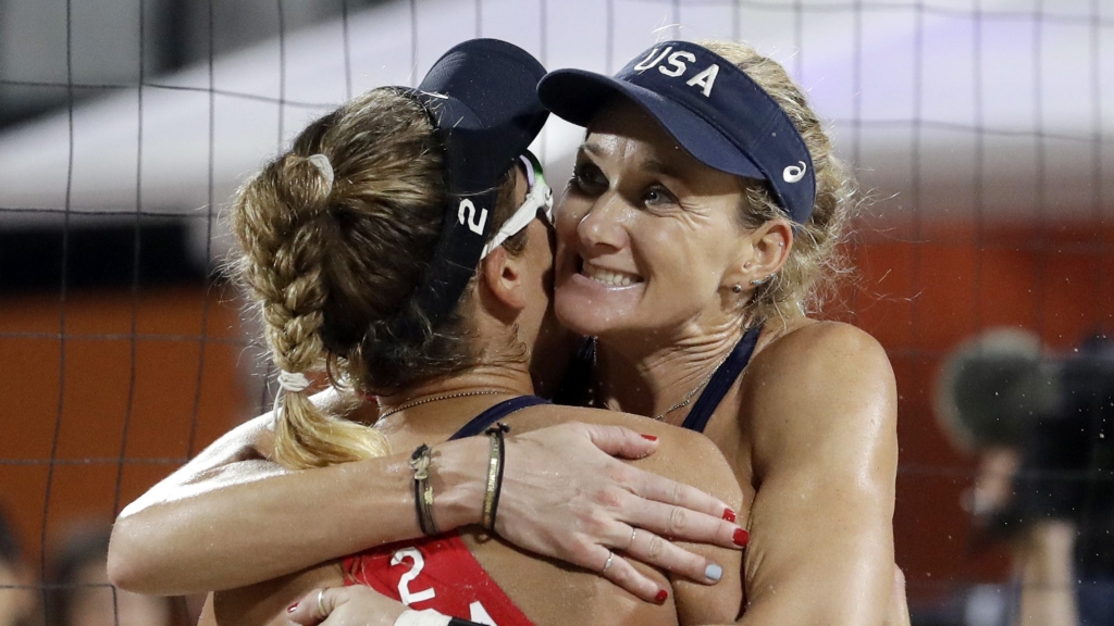 United States&#039 Kerri Walsh Jennings right hugs teammate April Ross after beating Australia during a women's beach volleyball quarterfinal match at the 2016 Summer Olympics in Rio de Janeiro Brazil Monday Aug. 15 2016. (AP