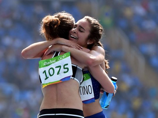 Abbey D'Agostino and Nikki Hamblin embrace after the race