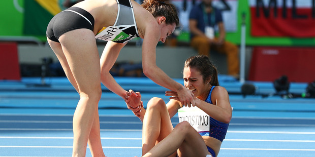 Abbey D'Agostino of the United States right is assisted by Kiwi Nikki Hamblin after the collision in the 5000m