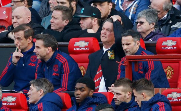 Louis van Gaal sits in the dugout with Ryan Giggs